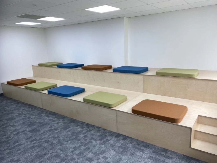 Bespoke tiered bench seating in the refurbished management suite collaboration area