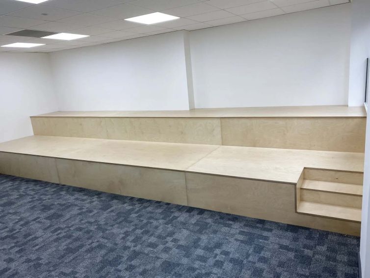 Bespoke collaboration zone with tiered bench seating in the refurbished management suite