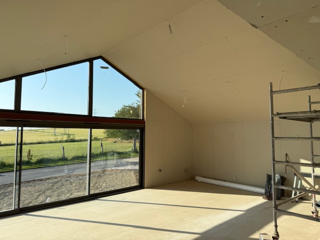 Interior of new extension with glazed gable overlooking the garden