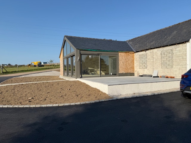 Home extension featuring large glazed gable and patio doors