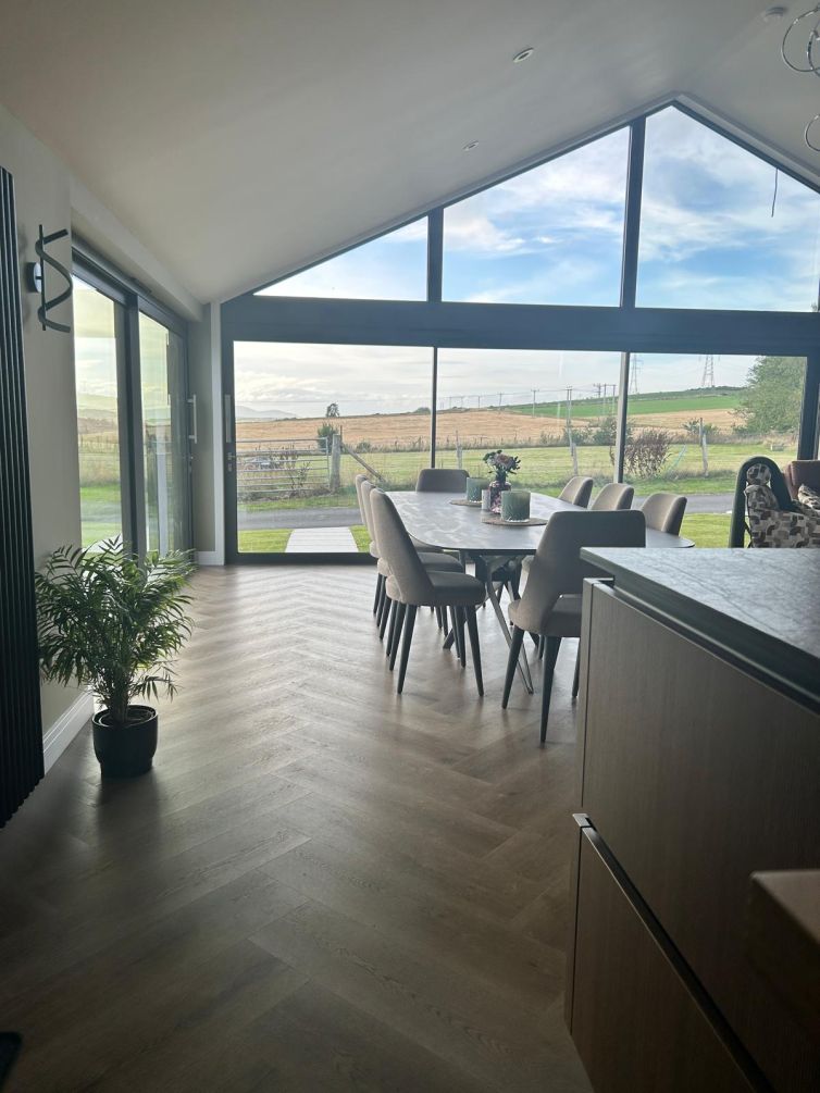 Completed home extension with landscaped exterior and new driveway