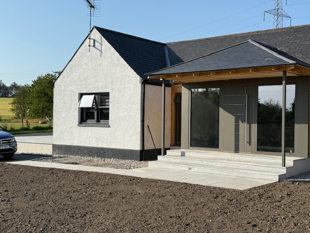 Rear home extension with large glazed doors and timber detailing